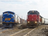 <b>End of the line on GEXR:</b> Goderich-Exeter's former F9A 1400 and 1401 sit with a cut of freight cars at the end of the GEXR Guelph N Spur (ex Fergus sub) while 582, (right) passes by. From this point on, the new owners, Ontario Southland Railway will take posession of the engines and bring them to Guelph Junction to eventually be worked on and returned to service (assuming all goes as planned). Note how many parts are missing - both engines were being used as parts sources for RLK 4001 in Goderich over the last few years<br><br>The Ontario Southland employees agreed with the following summary of why they were purchased - Inexpensive to buy, and inexpensive to move (Goderich to Guelph is relatively short compared to other potential units on the market) and only a Shortline stands between the two railways which ensures a low price for the movement. 