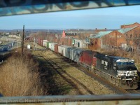 In response to Arnold Mooneys shot of NS 328 with CP 700 series power leading - here is a shot but in reverse - NS 9762 leading and NREX 783 (formerly CP 783) trailing with approximately 60 cars. The train framed in the graffiti soaked bridge rails, you can see 10 cars on the head end from the St. Thomas and Eastern Railway and about 50 empty auto parts cars from Ford Talbotville heading to the stamping plant at Buffalo.  NS 327/8 had but two weeks to live at this point and operated on an erratic schedule. Months prior you could count on this train running every day except when Talbotville was on scheduled shutdown.<br><br>The closest thing to this today is NS H3R out of Buffalo to Fort Erie - still using NS St. Thomas Division based Canadian crew - and who knows for how much longer that will last?<br>