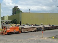 US Steel had recently purchased Stelco - but not much has changed at the Hamilton Works on this summer day. Remote Control SW900 Stelco #84 is switching gondolas in the main inbound/outbound yard - all blast furnaces were operating and US Steel was recieving at least two switches per day. Traffic consisted mostly of steel billets for export - however the Steel Train (Joint CN/SOR) also continued to operate. Note the vintage crossbuck.<br><br>
Today the blast furnaces are idle at Hamilton, no steel is being produced, a small Galvanizing line is operating, and the coke ovens continue to turn Coal into Coke for export to other US Steel blast furnace operations. This amounts to approximately a couple tank cars a week are switched into or out of US Steel Hamilton, a pittance compared to the 80 or so loaded cars daily being switched out by CN and CP at the time of this photo.