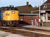  I was all set for a nice evening image of VIA #79 pulling into the station with VIA 6780 & 6627 when at the last minute I decided to grab a shot of the old MoW structure next to the Station when this young fille in short-shorts got in my way.  Thats the way it happens sometimes.
Co-incidentally, this locomotive is the same leader as on my last upload at Hamilton W in the snow; originally after the formation of VIA a lot of these former CN units were painted in the yellow/blue VIA scheme and "CN" applied to the nose for reasons I do not understand. Then they were painted out (as in this photo) and "VIA" applied later. Besides other experimental tweaking, "VIA" did appear on the front of some units in blue paint, although most were in red.