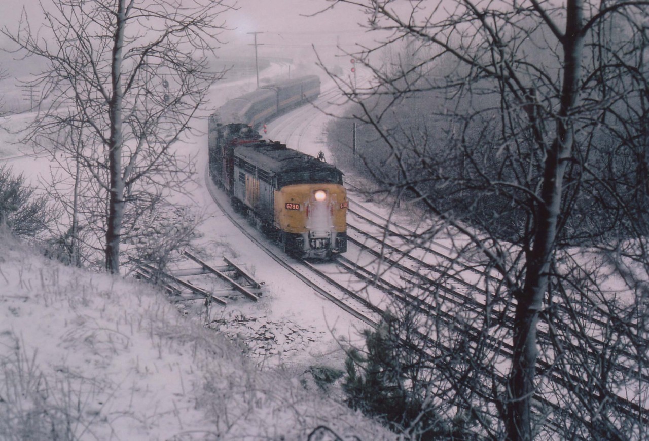 This is a reminder that WINTER is coming.......and this year it could be a long one. This photo taken from the  Royal Botanical Gardens overlooking the old "Hamilton West" shows VIA 6780 (I think it is 'CN' on the nose)and an unidentified CN passenger locomotive slowing into the curve at Bayview Jct. Not sure (no TT) but I believe it is the morning #70. A late spring storm makes this scene look like the dead of winter although it is already April!!