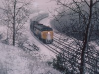 This is a reminder that WINTER is coming.......and this year it could be a long one. This photo taken from the  Royal Botanical Gardens overlooking the old "Hamilton West" shows VIA 6780 (I think it is 'CN' on the nose)and an unidentified CN passenger locomotive slowing into the curve at Bayview Jct. Not sure (no TT) but I believe it is the morning #70. A late spring storm makes this scene look like the dead of winter although it is already April!!