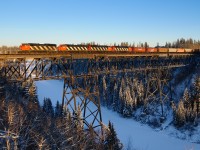 A classic lashup consisting of CN SD60Fs 5547, 5545, 5504 and SD50AF 5502 lead train M34791-14 across the Pembina River between the small towns of Entwistle and Evansburg, Alberta. CN is in the process of shuffling 13 SD60F type units to Prince George, BC where they will work primarily on the ex. BC Rail lines to the north and south. Prior to this, almost every 5500 was in captive service between Edmonton, AB and Thunder Bay, ON. It sure was a nice treat to get 4 of them on the point.