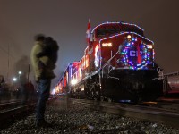 Many gather around this years CP Holiday train as it lights up Lambton Yard. A father and his son stay somewhat still for the 13 second exposure, as they observe the lead unit.