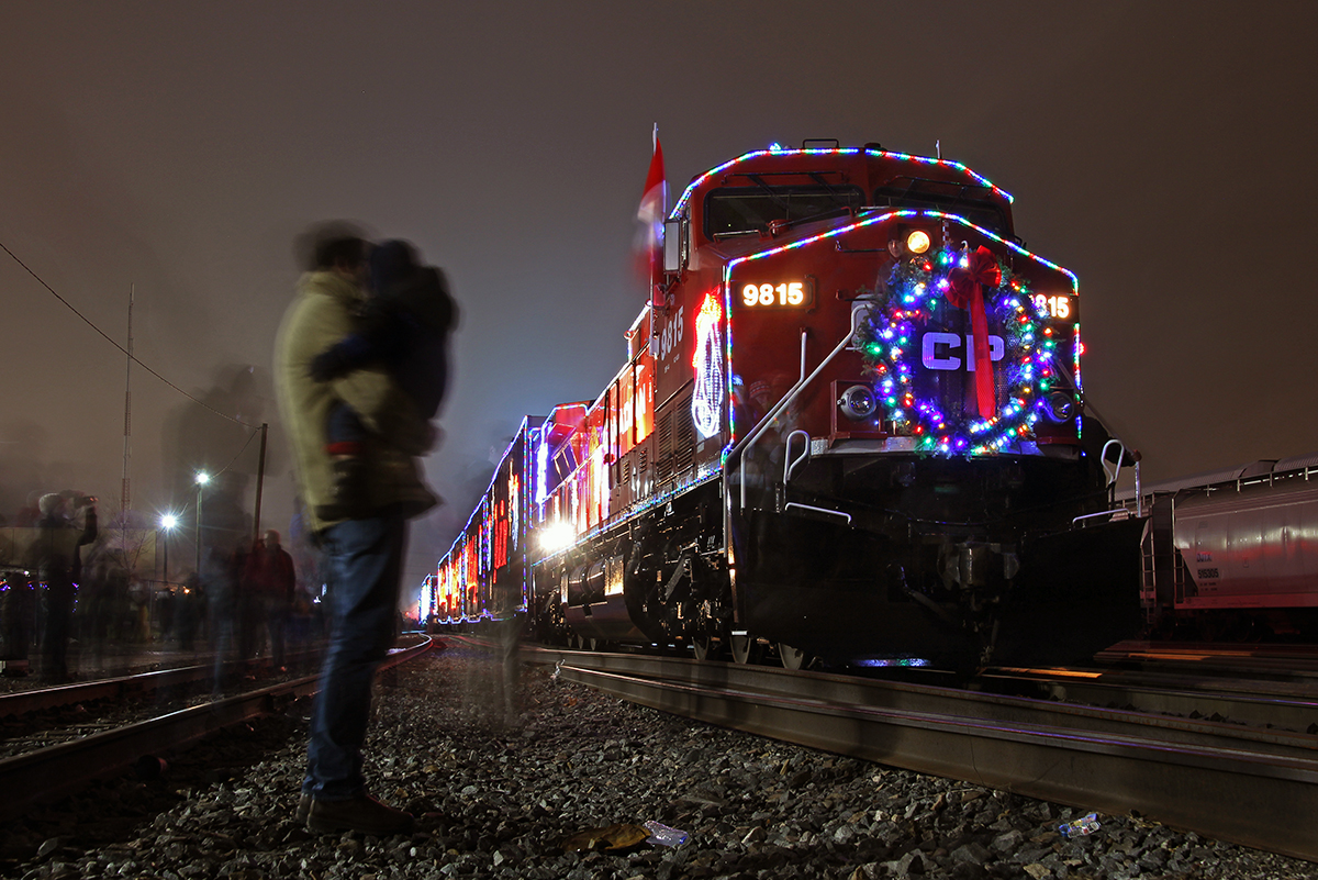 Many gather around this years CP Holiday train as it lights up Lambton Yard. A father and his son stay somewhat still for the 13 second exposure, as they observe the lead unit.