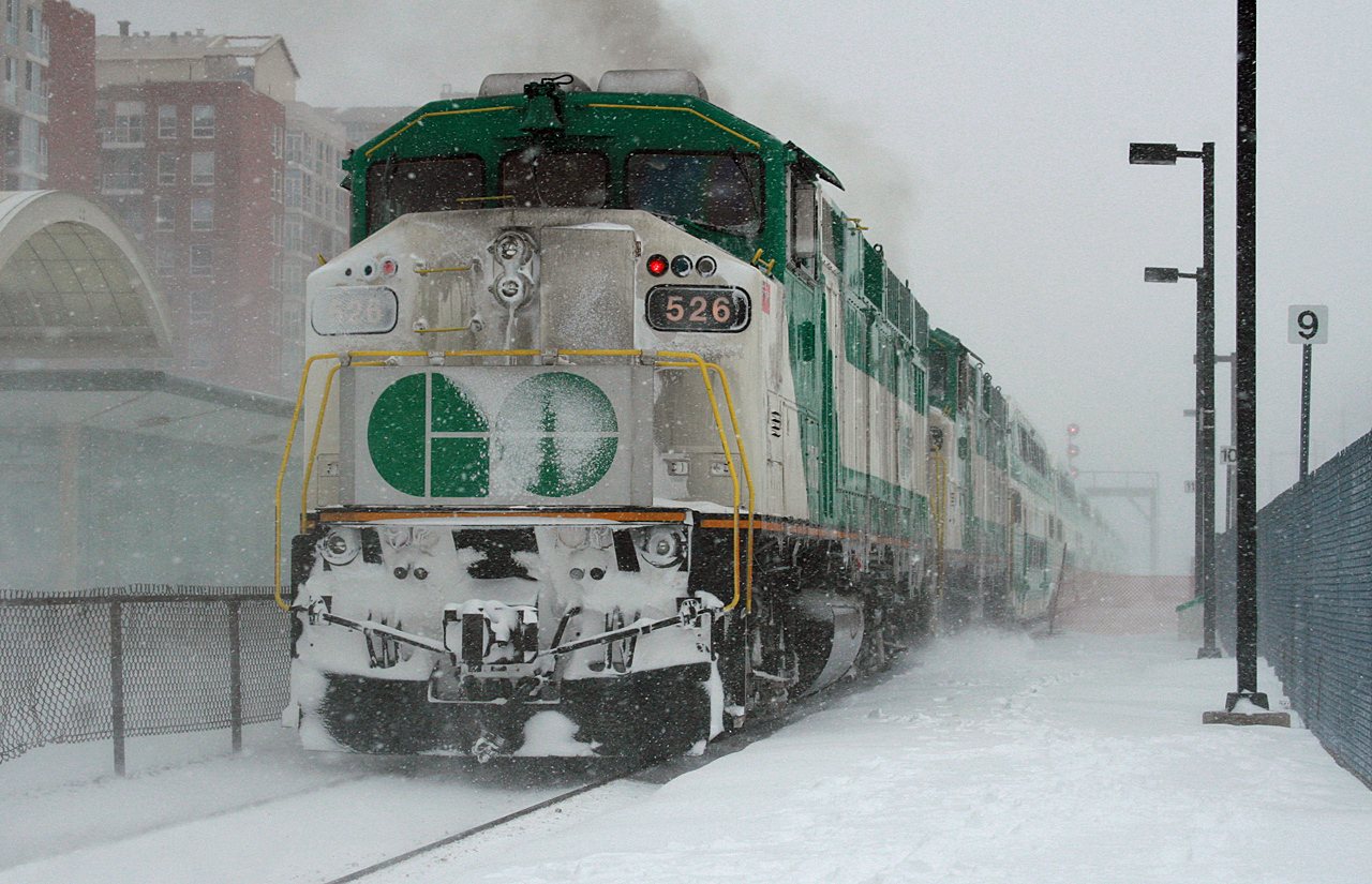 The show must GO on.
Amid a snowstorm that, by the rest of Canada's standards would be considered a light snowfall, but by Toronto standards a minor storm like this results in hour long delays on the highway, car crashes and I'm sure a few drivers went into the ditch- However, GO Transit train 919 shoves out of Oakville Station right on time with a pair of F59s providing the power.