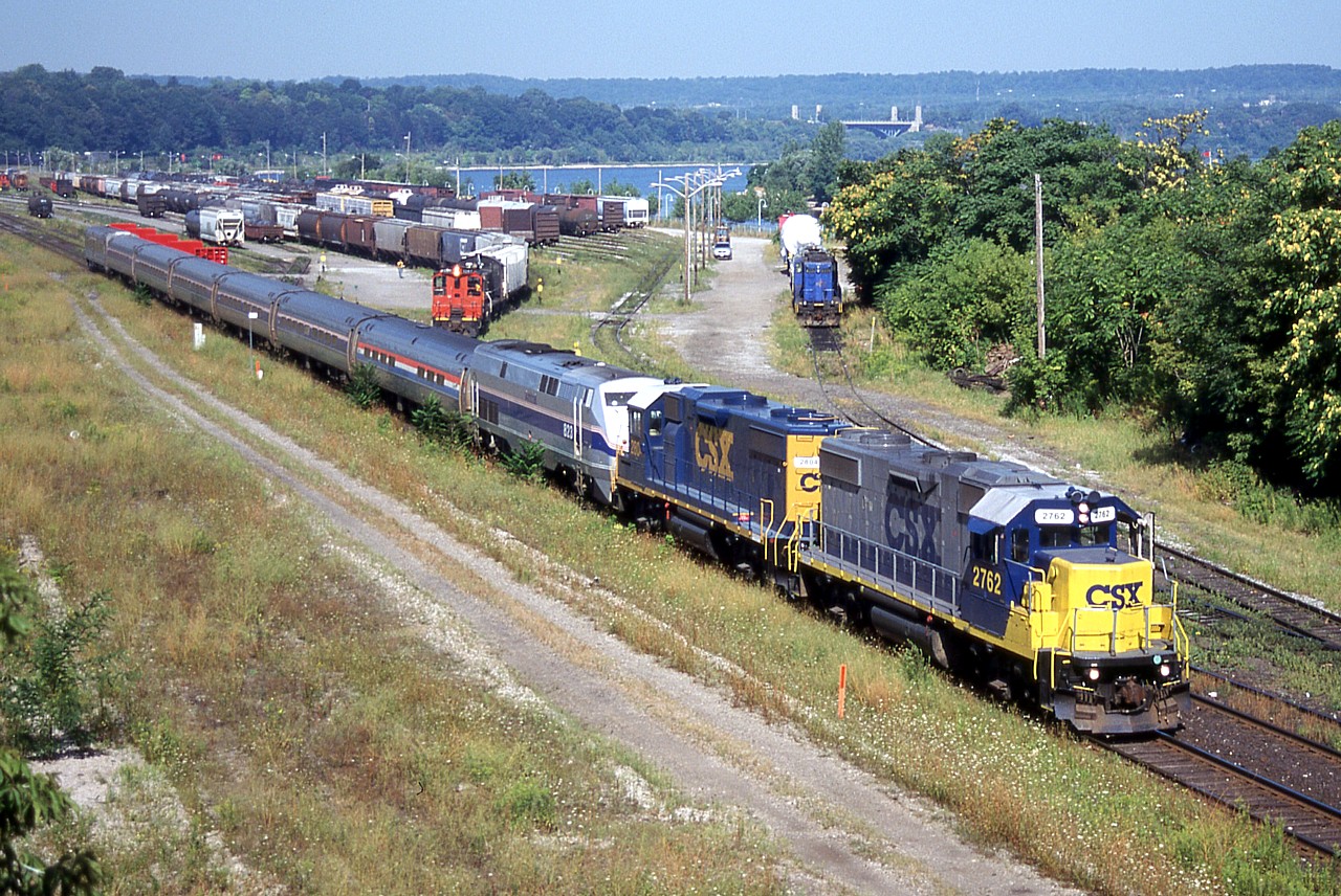 Desperate times call for desperate measures. Amtrak 823 kicked the bucket on the Maple Leaf the day before, and a pair of GP38-2s from CSX’s Frontier Yard in Buffalo was summoned to power the train to Toronto. The following  day, the pair of CSX units are seen leading the eastbound back towards Buffalo, passing SOR’s Stuart Street yard in Hamilton.