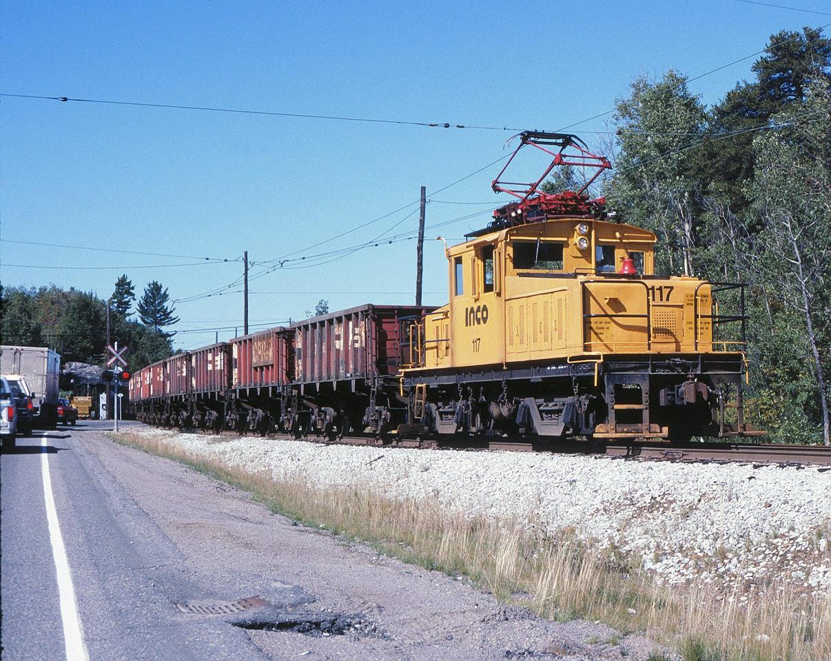 INCO 117 just picked up empties at the CP interchange for a trip down hill to Levack, ONT.   9/16/1993