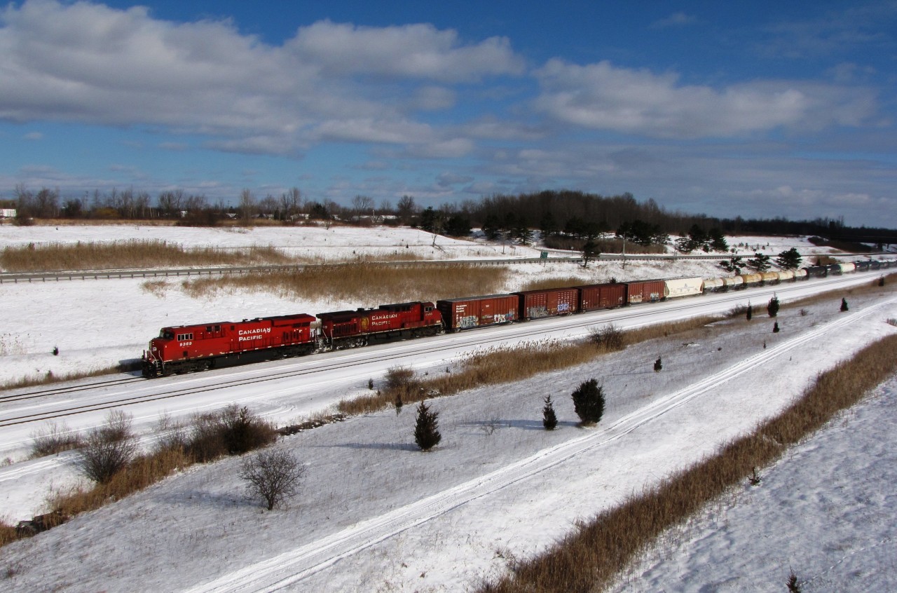 A north bound CP train led by #9386 is seen traveling through the Townline Tunnel Cut. It will soon duck under the Welland Canal and procced to Welland Yard. First train of the new year.