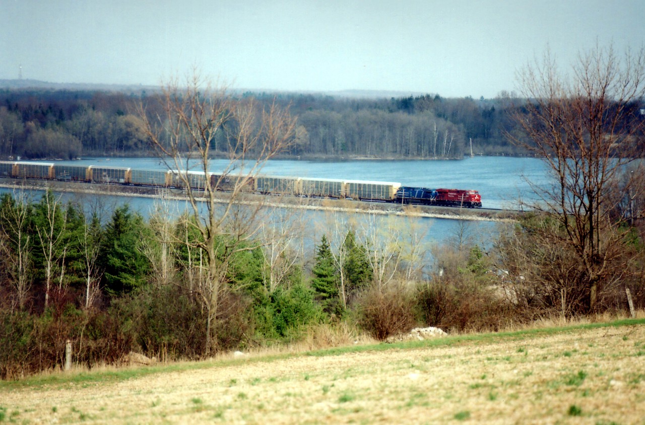 Afternnon westbound #245 running a bit late, with CP 9352 leading a blue CEFX over the Mountsberg Causeway. The ice is mostly melted and spring is not far off.