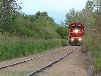 [Editors note: accepted due to rarity of the movement] The CP Hoadley sub was quite inactive between 2008-2010, until major work had been done replacing ties and putting down some new ballast. This is a shot of the work train from which ties were unloaded by a crane to be replaced later. The quality of the track prior to tie replacement is evident. Also, the train was going at literally 1 mph so the crane operator would have adequate time to pick up ties from the car ahead and drop them onto the ground where required.