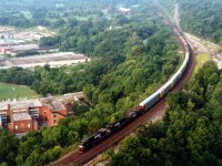 Here is an example of the typical NS Talbotville,ON (St. Thomas) to Buffalo,NY autoparts train #328, in this view imaged in an overview from Dundas Peak. NS 8696, 8563 and about 15 cars, part autoracks and part cubes. The large buiding in lower left was former a High School, now closed and being converted to Condos.