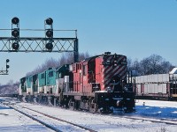 Return run - it is Sunday afternoon: GO 7xx, 7xx and 504 are on the Leaside crossover heading down to Don and onward to their owner. CP Rail RS-18 #8762 - the future #1803 - is the CP crew's return ride. December 1979 Kodachrome by S. Danko.
