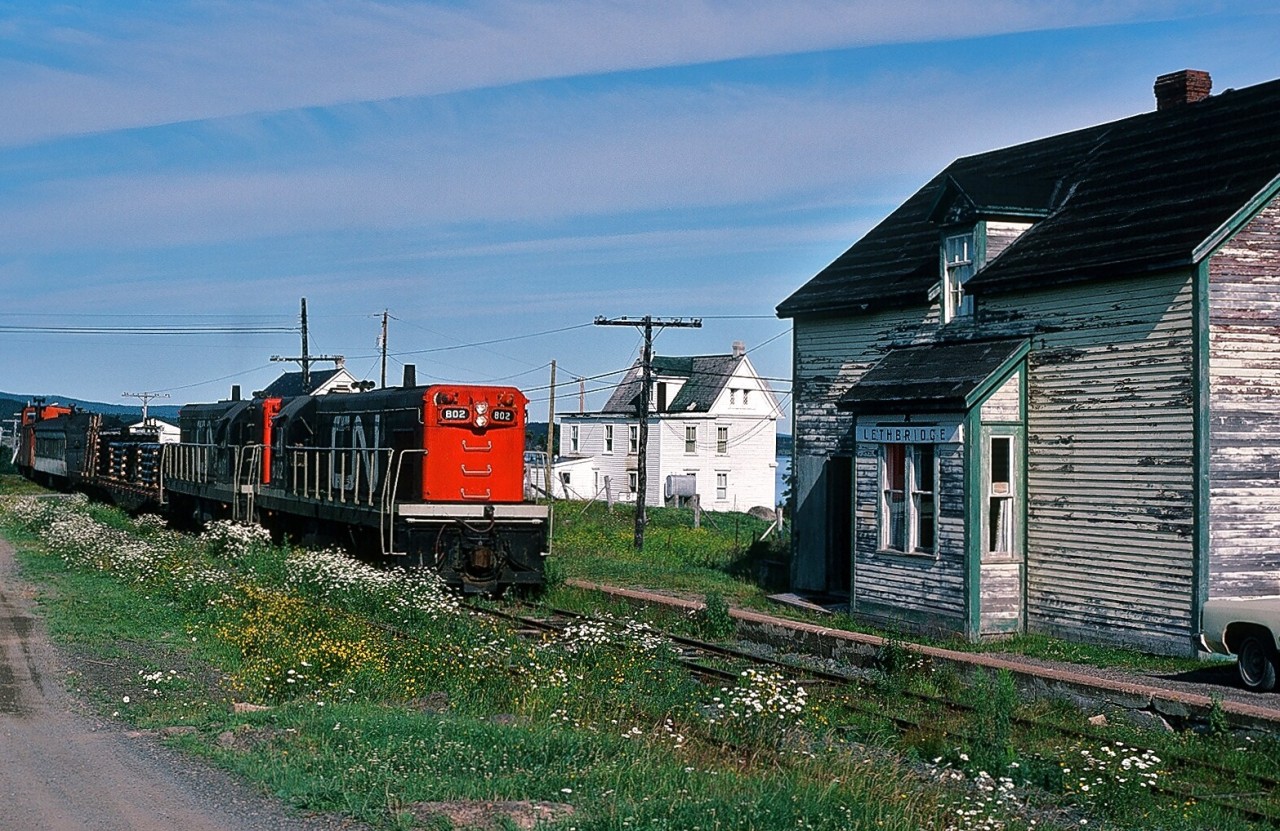 A special place – The Rock. 
Wonder Train. GMD built G-8's #802-801 (with Caboose #6061) are in charge of the Wednesday only Bonavista to Clarenville Terra Transport #205. Wondered why – in 1982 - why this train existed.
...no other place like it.....
August 2, 1982 Kodachrome by S.Danko.

More Terra Transport:
  Terra Transport #232 near Clarke's Beach  
    Terra Transport #206 near Lockston  
    Terra Transport power for #204, Port-aux-Basques  

sdfourty.