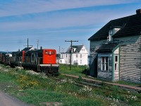 A special place – The Rock. 
Wonder Train. GMD built G-8's #802-801 (with Caboose #6061) are in charge of the Wednesday only Bonavista to Clarenville Terra Transport #205. Wondered why – in 1982 - why this train existed.
...no other place like it.....
August 2, 1982 Kodachrome by S.Danko.
<br>
More Terra Transport:
 <a href="http://www.railpictures.ca/?attachment_id=7438"> Terra Transport #232 near Clarke's Beach </a> 
   <a href="http://www.railpictures.ca/?attachment_id=6808"> Terra Transport #206 near Lockston </a> 
   <a href="http://www.railpictures.ca/?attachment_id=6608"> Terra Transport power for #204, Port-aux-Basques </a> 
<br>
sdfourty.
