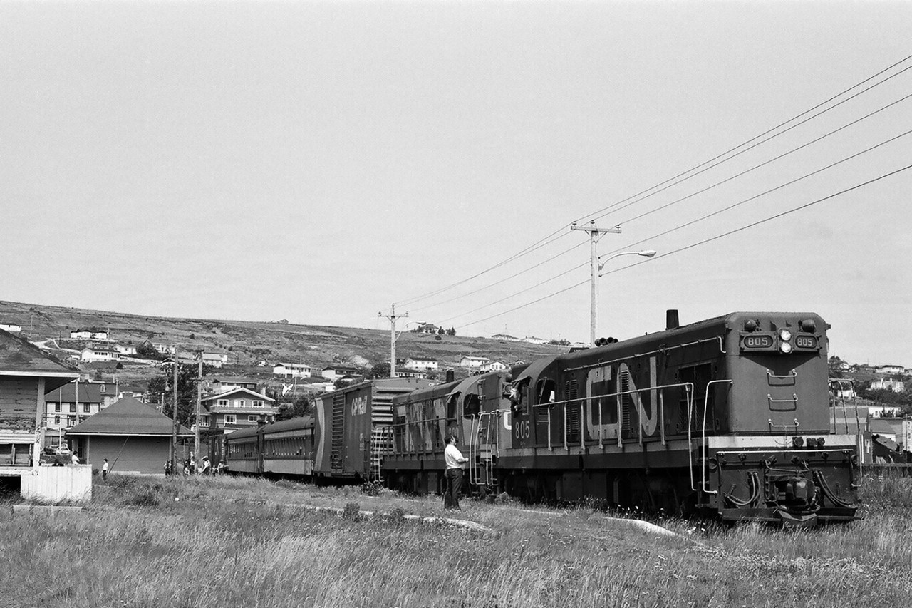 A special place – The Rock. 


Two trains in one: Terra Transport train #231 - Tuesday, Thursday, Saturday - has spotted the CN box bar and lifted the CP box car at Carbonear station,


 TT #232's crew is on lunch break prior to departure for St.John's: powered by GMD G8's TT #805 - TT #800. 


Carbonear Freight Shed on the extreme left. 


...no other place like it.....


August 7, 1982 negative by S.Danko.


More Terra Transport:


  Terra Transport #232 near Clarke's Beach  


    Terra Transport #206 near Lockston  


    Terra Transport power for #204, Port-aux-Basques  


    TT #927, Port-aux-Basques  


   TT #929, Corner Brook  


sdfourty.