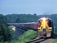 Southbound Train No. 2 is crossing the Bellevue Trestle on a nice warm summer afternoon. The Agawa Canyon Tour was becoming very popular then and as a result No. 2 kept getting bigger and later with all of the Flag Stops to deal with, as well as regular station stops. Within a couple of years the Agawa Canyon Tour trains would run as separate trains (No. 3 and 4) to Canyon and return as a second class passenger train. 