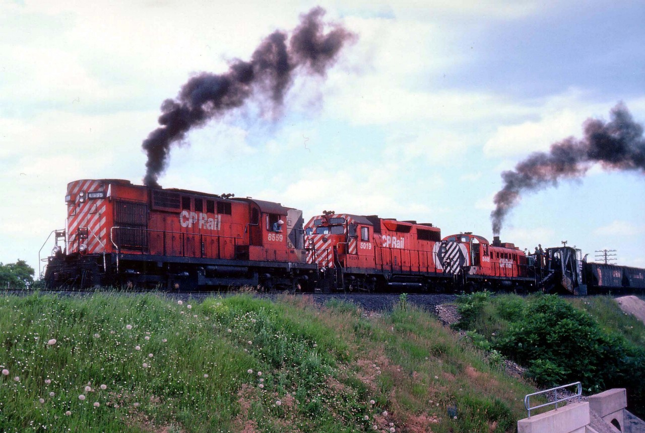 In reply to that smooth Ballast Train contribution from James Adeney (attachment_id=7780) from the other day regarding his comments on the "ugly" ballast put down on the Galt sub over the summer of 1979, here is another example shot in Milton 2 days previous. The train is working its' way westward, and this is a brief moment in time where tremendous clouds of grey sooty dust was not billowing thru the air. Instead, it was stack exhaust. And true to James' words, the power was always interesting, always changing.  Here we see RS-10 #8559 and GP35 5019 along with that straggler, RS-3 8446.