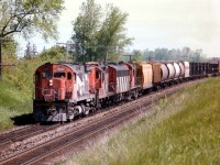 Nice assortment of power on this morning westbound, seen approaching the Fairchild Creek trestle a couple of miles outside of Brantford. End of train is crossing Power Line Rd. Power is 3237, 4121, 9195 and 3118. Leaders such as this C-424 were getting rather scarce by 1984, quite a few had either been retired or sold off.