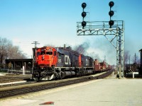 CN 403 is passing the east end of the Brantford yard @ 13:50. A pair of MLW M636's CN 2302 - CN 2315 arrive with 49 cars and after setting off 4 cars depart @ 14:03. CN van 79212 brings up the rear on this train.