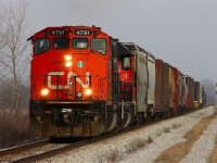 CN A439-23 accelerates up to track speed as the last car passes Ringold diamond just outside of Chatham Ontario; 439 is always a favourite for me to shoot with it's retro EMD power and this widecab is no exception.