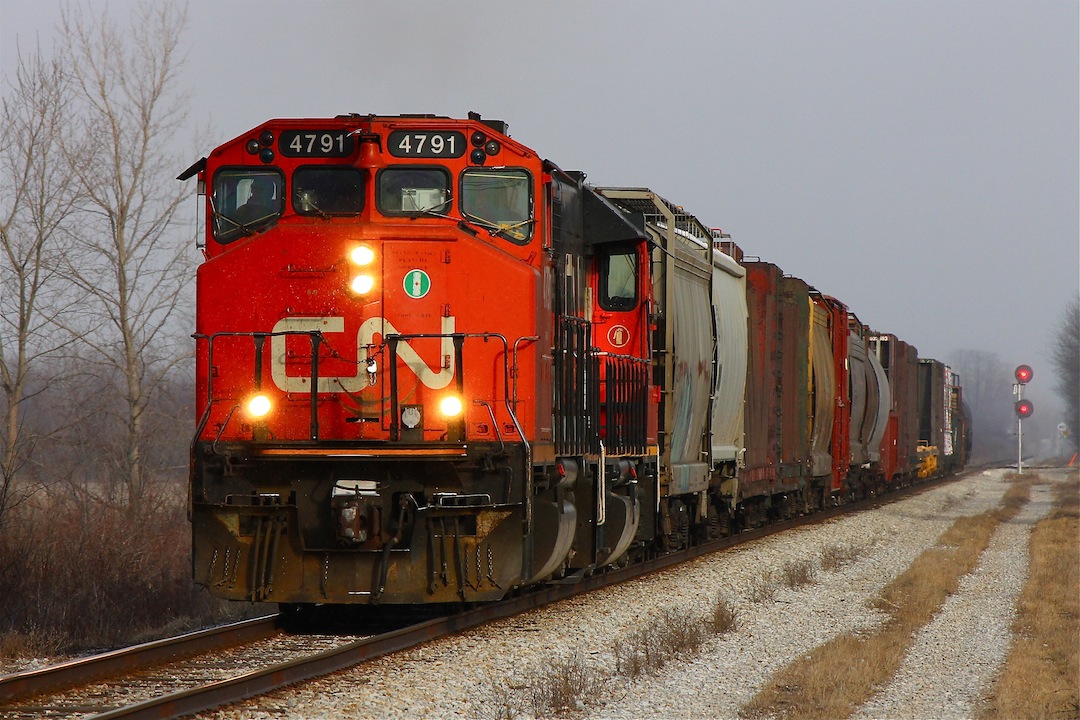 CN M439-23 accelerates up to track speed as the last car passes Ringold diamond just outside of Chatham Ontario; 439 is always a favourite for me to shoot with it's retro EMD power and this widecab is no exception.