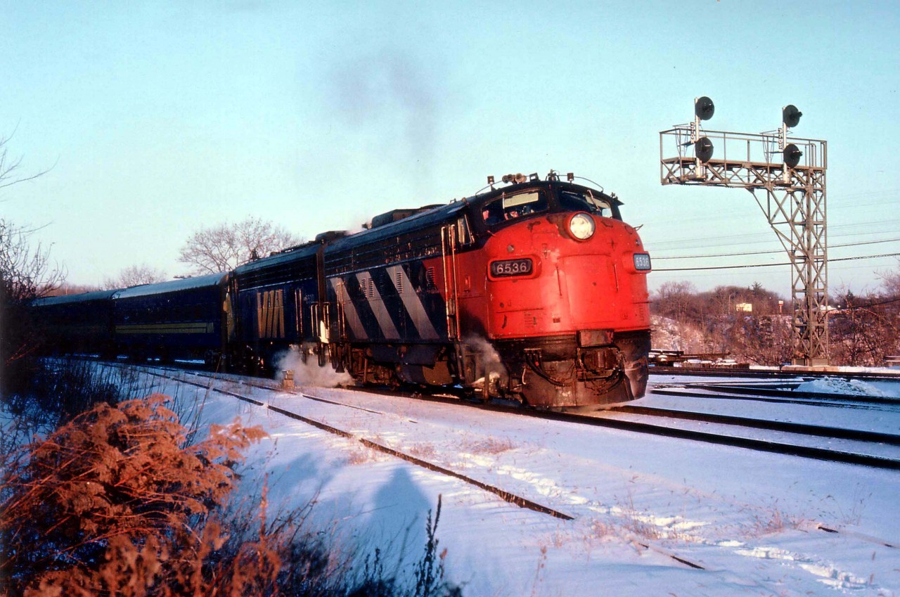 Late afternoon on a bitterly cold day in January 1981 as VIA #75, with leader 6536 still in CN colours with the "CN" painted out leads sister 6530 westbound onto the Dundas Sub thru Bayview Junction. And one can see the photographer will live on in his own shadow. :o)