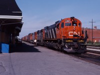After grabbing orders (still visible in the cab window) the trio of big MLW's powering CN 306 accelerate out of Saint Hyacinthe  306.