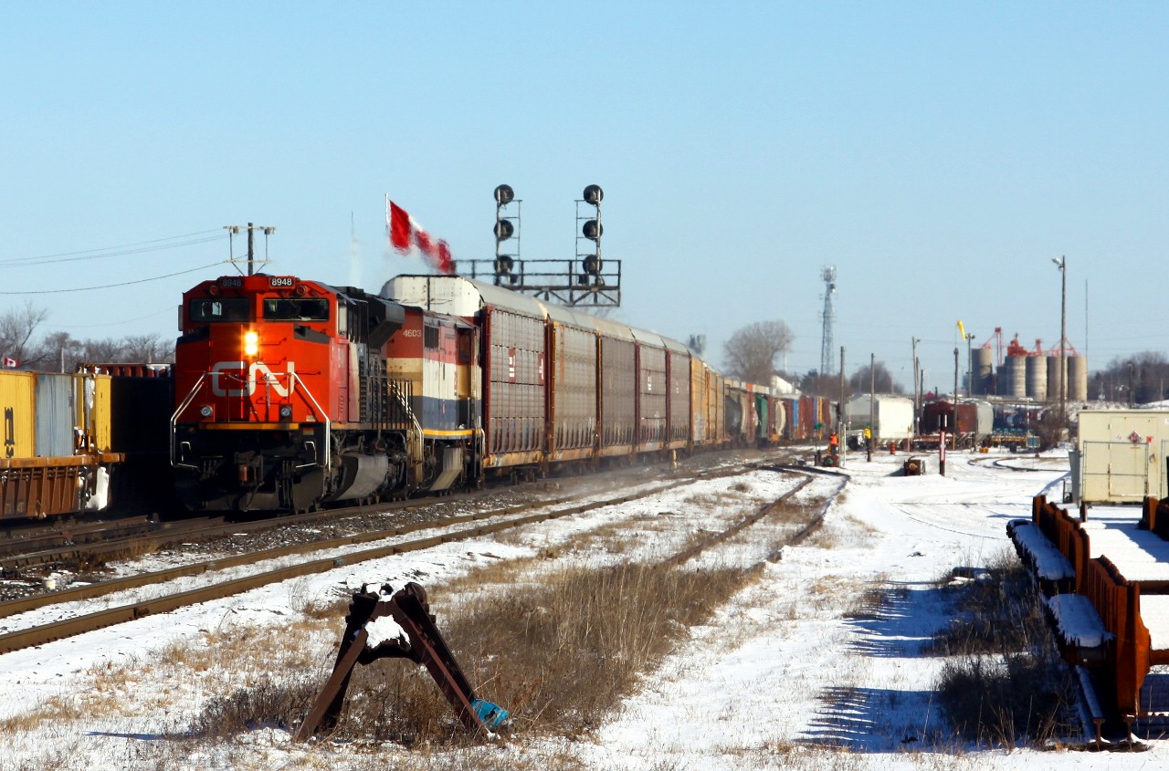 Showtime: A 4-train meet takes place at London Jct, alive with activity in the early afternoon. CN 8948 leads a late-running and relatively short 393 westward through the junction, while also running late, CN 148 runs eastward on the north track (CN 8010 east). Meanwhile, at right, the last few cars of CN 509 (also running late) slowly roll down the yard lead as the crew yards their train coming in from Sarnia. Not seen, VIA 85 is waiting north of the junction on the GEXR Guelph sub waiting for a clear track to the depot. Just after this action settled down, CN 584 and VIA 73 also put in an appearance. Six trains in less than 15 minutes, not bad!