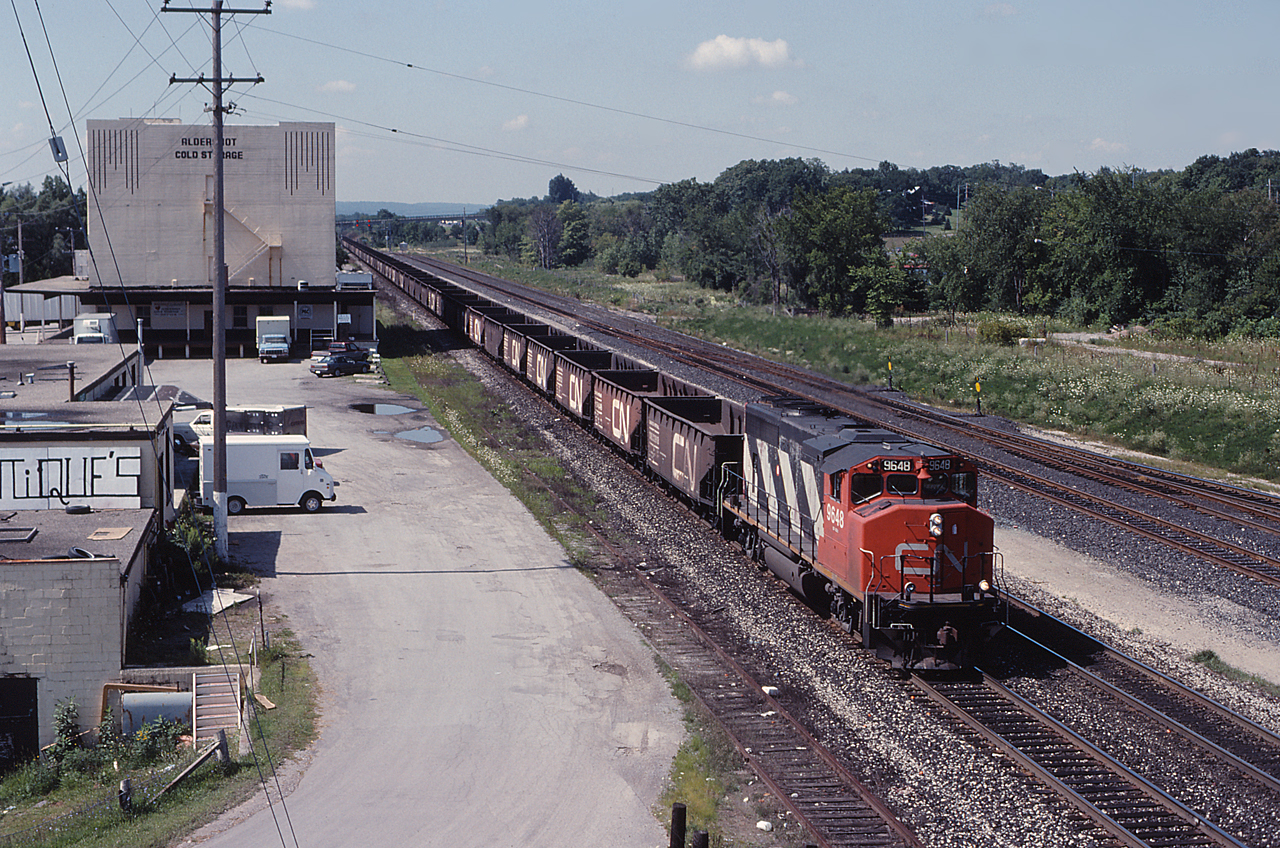 CN 9648 leads an eastbound ballast train through Aldershot