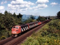 The CN version of the Nanticoke Steel Train, in this image on the move from Hamilton to the affiliated steel mill in Nanticoke by way of Brantford and south was very short lived running with this A-B-A lashup. There always seemed to be some mechanical problem and it wasn't long before GP9s were in the mix and after that, the GP40 Widecabs took over, making this, in the hearts of the fans, just another train heading west............
Seen here approaching Mile 1 Dundas sub are CN 9166, 9195 and 9177. The bridge in the background supports Old Guelph Rd.  Winning "a fight with the cloud" was nice. :o)