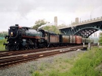  It was June 2003 when CP's grand old steam engine 2816, touring Canada, made the rounds in Ontario, having run southbound over the big Parry Sound bridge on June 5th and returning north over same on June 22nd. It was a month when all the train nuts were foaming in overdrive. This one was rather bad as well. :o)  The handful of fans who ventured out around the High Level Bridge at the west end of Hamilton became increasingly disappointed as the prevailent sunshine disappeared and a cloud provoked drizzle took over while the train was delayed somewhere up the line around Waterdown due to fallen trees, of all things. Speculation of vandals in action was the general feeling, but I never did find out what happened. Anyway, it all worked out in the end and the train put on a grand show as it rolled by; this photo now a treasure in the sense that latest rumour has it CP has the old 2816 up for sale. We may never see it run in Canada again.  A huge loss.