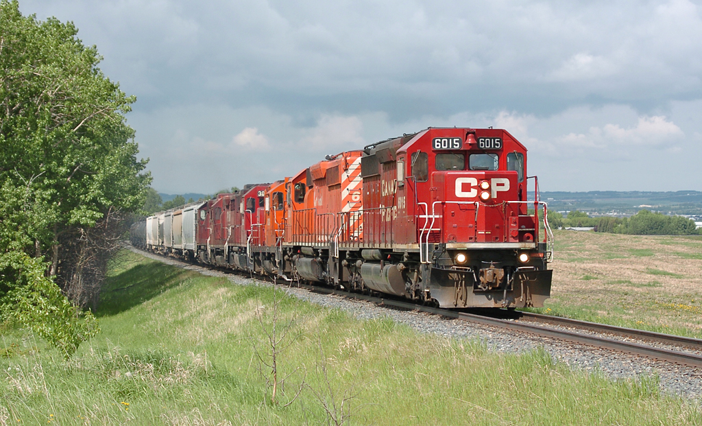 A heck of a consist for this little branchline train - CP SD40-2s 6015 & 6011, GP9u 8221, GP38-2 3035 and matching control cab 1125, and finally GP38-2 3118. This consist brought the train to Dow at Prentiss, and then the SD40-2s were left in front of the Lacombe viterra terminal with the Dow train while the other 4 units continued the journey Eastward onto the Lacombe sub.