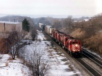 A very overpowered and short CP #557 on February 5, 1993 was eagerly awaited by the local railfan population. No wonder!!  It featured one-of-a-kind CP 8921 (RSD-17)followed by 4711 (M-636 converted to caterpillar engine in 1988)SD40-2 5601 (ret'd 2002), CP 4743 (another Big M) and SD40 5547 (ret'd by 2004) and maybe a dozen cars in tow. This image was taken on a rather warm morning for dead of winter, ground fog obvious from the Lemonville Rd bridge over the CN in Aldershot,ON.