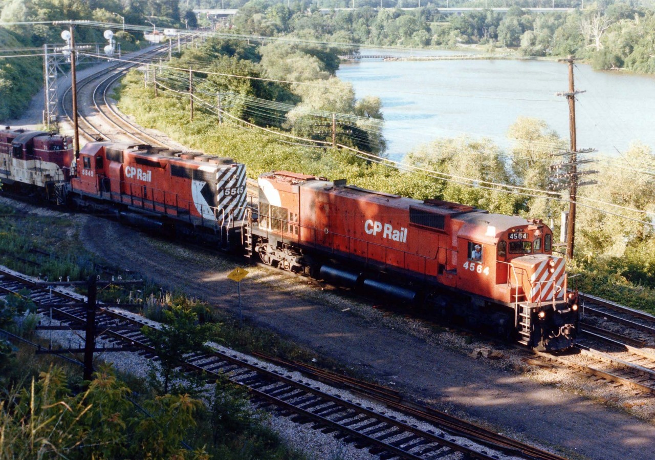 This image needs an explanation, but unfortunately I do not have one.  Here we see what appears to be the daily Toronto-Hamilton TH&B "Starlite" with CP 4564, 5545 and TH&B 74 coming off the CN 'Cowpath', of all places. The CP Goderich (now Hamilton) sub is in the foreground. Just by chance I happened upon this scene while checking out Bayview on an early summer evening. Too bad the shadow mars what is an image in nearly 40 years had never seen the likes of here before nor since.