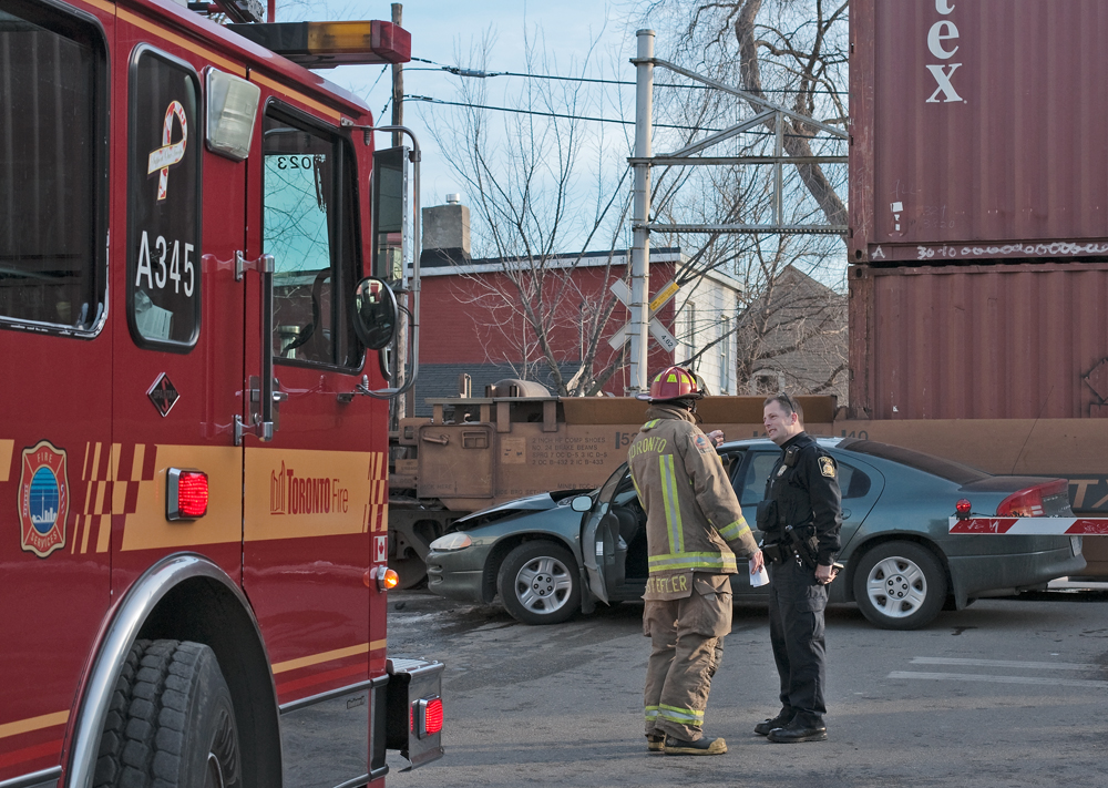 Minor accident yesterday from a result of a train car collision, luckily the train was doing 15 MPH and the occupants of the vehicle evacuated before the collision. Toronto Fire and CP Police coordinate a plan to move the train out of the way and the vehicle towed.