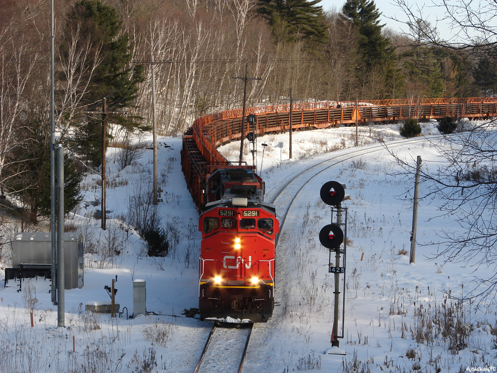CN O48331 04 - CN 5291 North pulls out of the siding after a meet with 104, they'll be running ACOT up the CN Bala sub this morning to avoid slowing up 2 other Northbound's behind them all heading up the Directional Running Zone for restricted meets with a Southbound Dimensional train heading against the flow of traffic down CP's Parry Sound sub.
