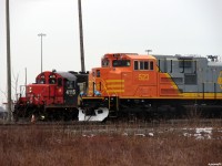 [Editors note: Accepted due to 'HOT' news item]  Shop switcher CN 4115 pops up beside brand new QNSL 523 on her way to lift a couple of these QNSL units and move them up to the other end of the shop complex. Taken from city, not private property. 