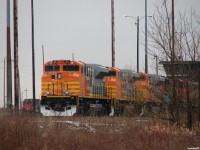 [Editors note: Accepted due to 'HOT' news item]  Brand new and fresh from Mexico, QNSL SD70ACe's 517, 516 and 514 sit outside the shops at CN's MacMillan yard, waiting for the shop switcher to return and run them around the horn to the other side of the shop area to join 7 more QNSL SD70ACe's all heading Eastwards together. Photo taken from city, not private property.  
