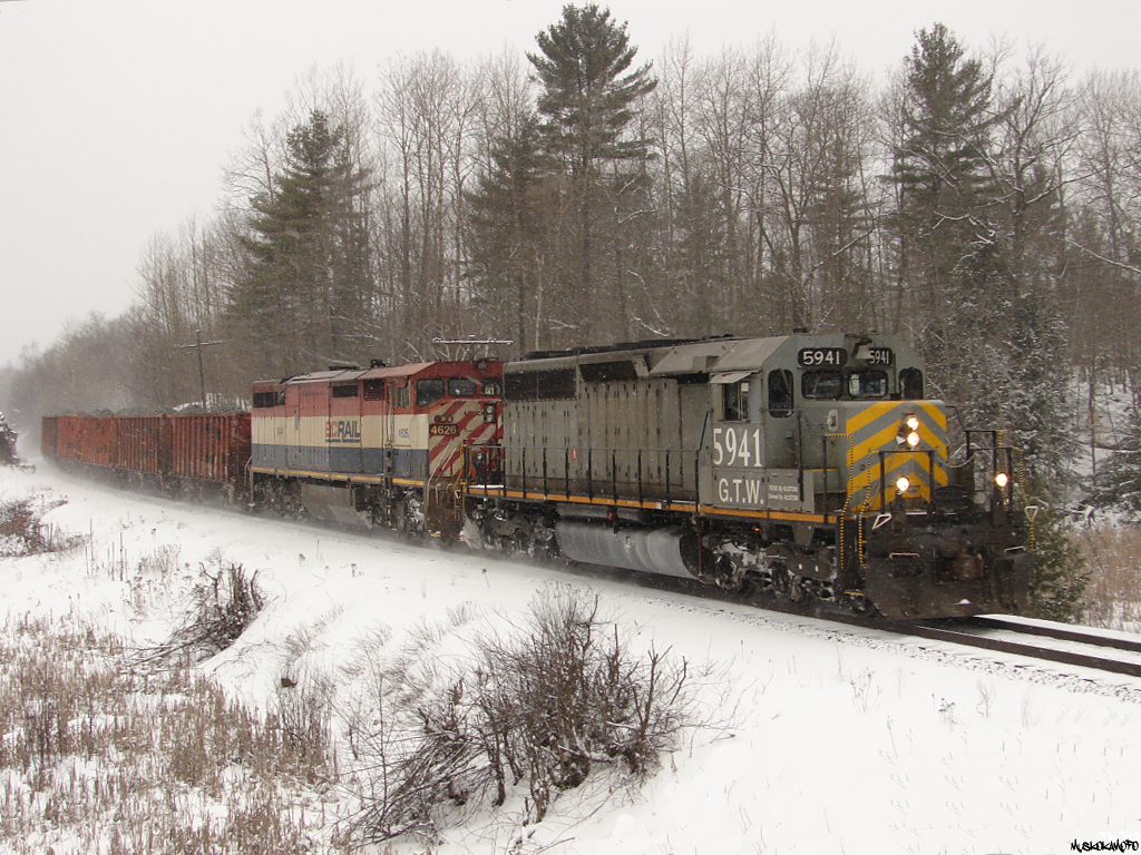 CN X31431 18 - GTW 5941 South pulling hard to maintain speed working their way uphill heading South with a train of frozen ballast loads, and extra traffic from the mines originating out of Sudbury.