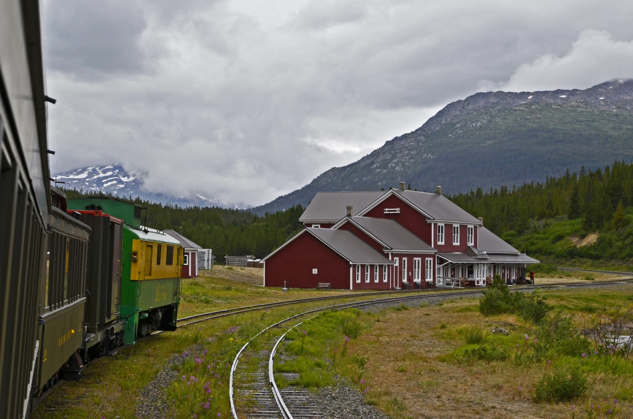 The Carcross to Skagway train carrying tourists, hikers, campers (like us) and an occasional freight container, is approaching its lunch-stop at Bennett, BC. A tasty lunch is awaiting us in the station dining room.