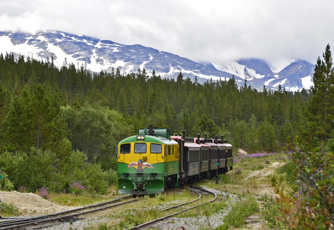 The WP&Y Carcross train from Skagway is approaching the Bennett BC station on a (typically) overcast summer day.