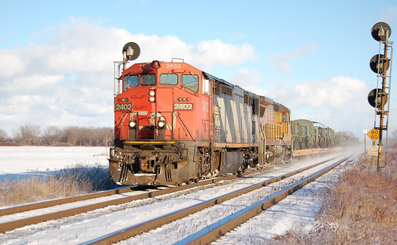 CN 2402 leads UP 9334 with an eastbound unit train of millitary equimpent in Sarnia. The cold temps was worth the wait for this one.