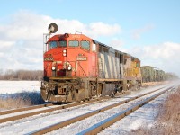 CN 2402 leads UP 9334 with an eastbound unit train of millitary equimpent in Sarnia. The cold temps was worth the wait for this one. 