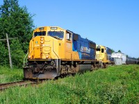 Ontario Northland train 214 throttles up departing Englehart in to the brilliant morning sunshine.