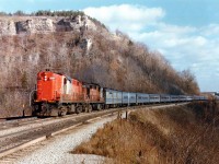 VIA Rail is still in its infancy and it is rather obvious as CN Tempo units 3151 and 3154 are powering an eleven car westbound approaching Dundas Station. For those familiar with this area, note the "guardrail" up at the Peak Lookout. And note the CCSL conveyer is still intact, seen at the extreme right of the photo.