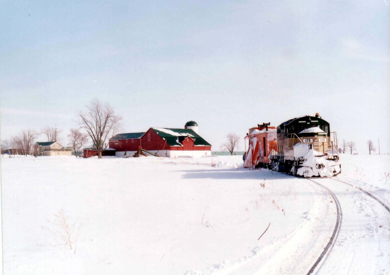 After making sure the line was clear from Clinton Jct down to the end of steel at Centralia, GEXR 179 and plow x-CN 55437 start the run back north. They picked up one empty bulkhead at Centralia to take back with them.