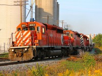 The famous CP Rail Expressway still sporting it's classic EMD power is seen whipping through Streetsville with the setting sun casting beautiful golden light onto the scene.