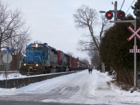 Headed for Toronto's MacMillan Yard, GEXR 432 rolls through Guelph, Ontario on a snowy post New Years day with a venerable pair of EMD's in charge. Intersecting Kent Street, this could be considered Guelph's version of street running.