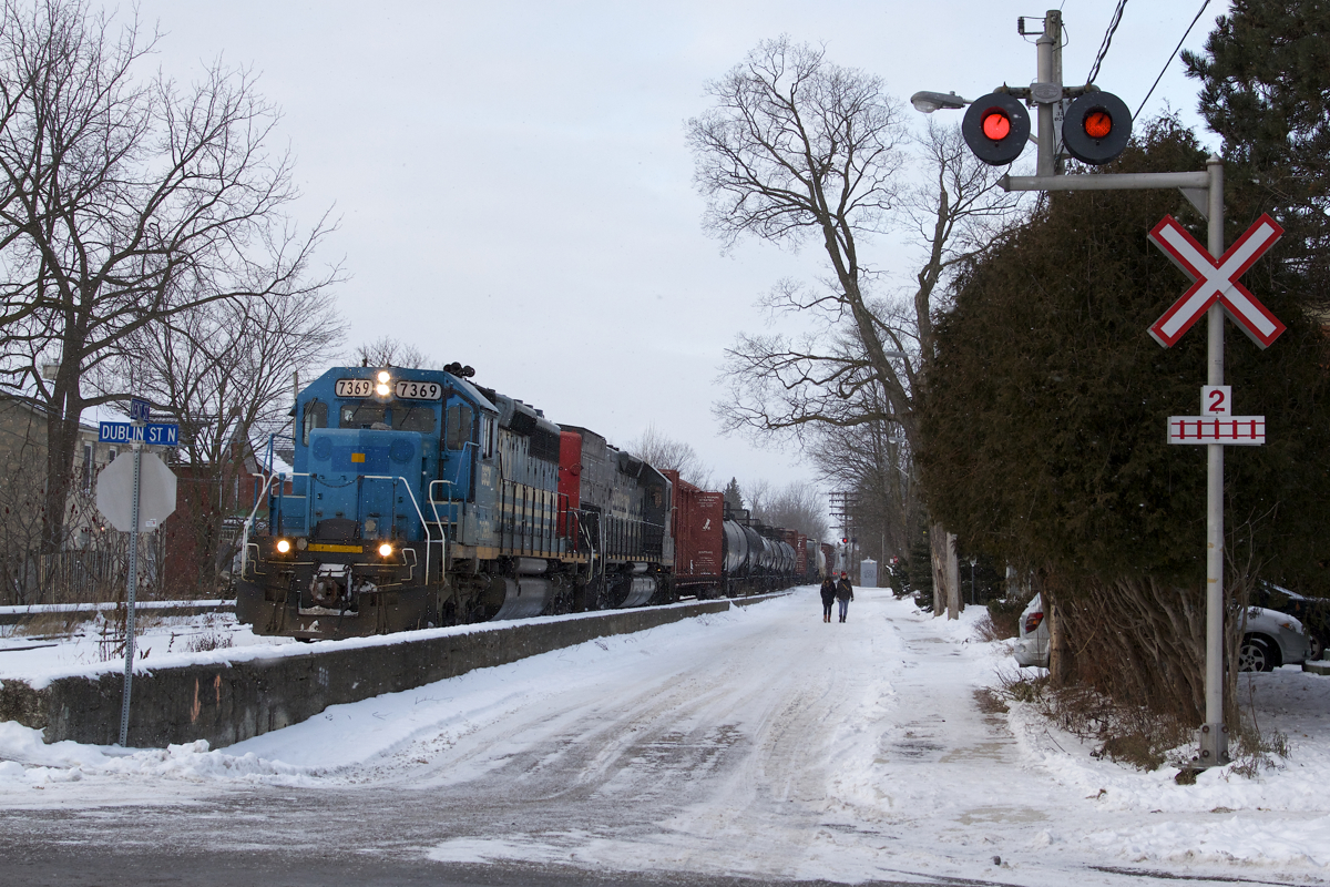 Headed for Toronto's MacMillan Yard, GEXR 432 rolls through Guelph, Ontario on a snowy post New Years day with a venerable pair of EMD's in charge. Intersecting Kent Street, this could be considered Guelph's version of street running.